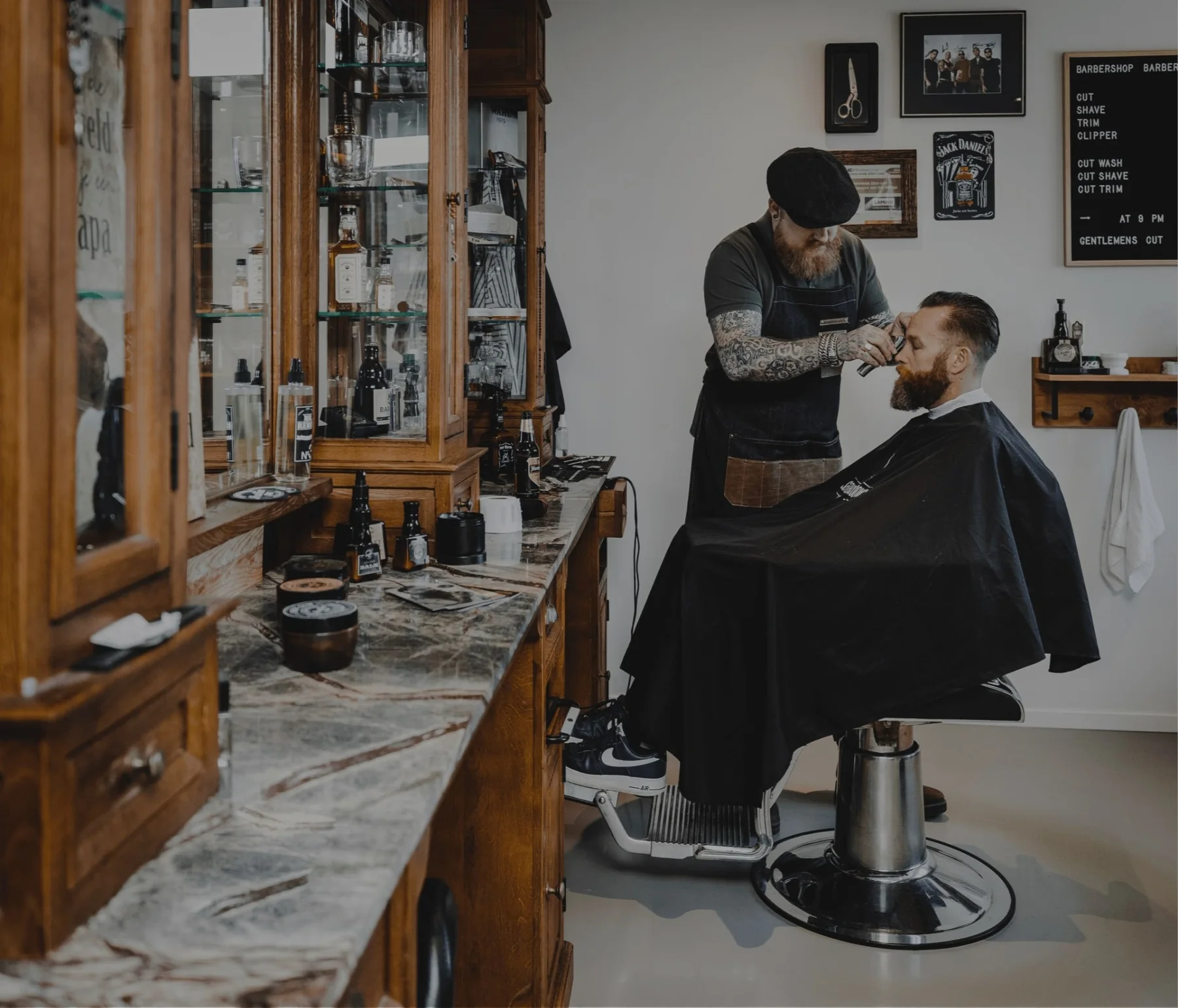 Barber working on a client in the shop — full scene